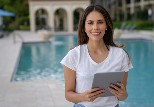 A Rental Property Manager in Florida smiling and standing in front of a pool